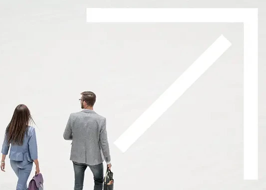 Three employees walking through an atrium