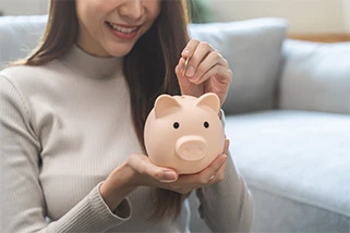Woman filling up a piggy bank