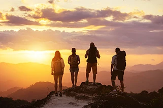 Group of walkers at sunset