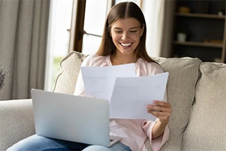 Lady checking documents on a laptop