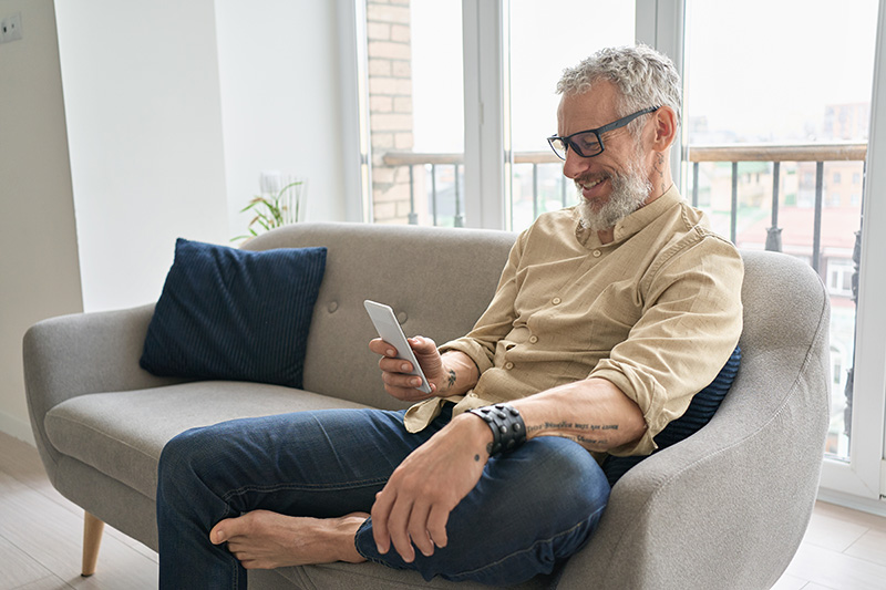 Man sat on couch on mobile